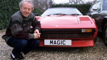 Paul Daniels, famous English magician, posing beside his red Ferrari with the private number plate 