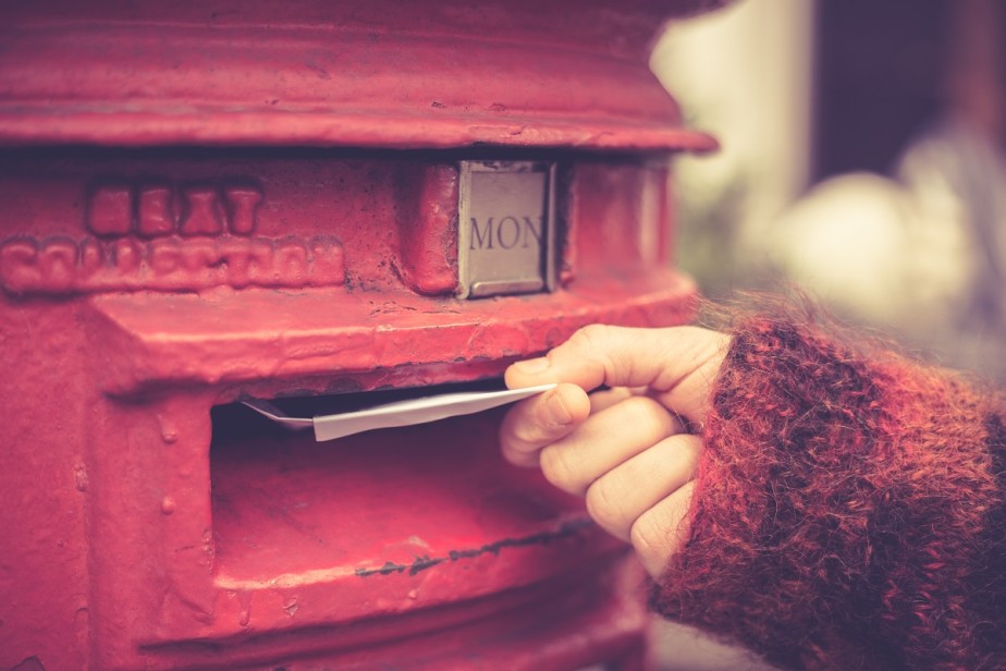 Woman posting envelope.